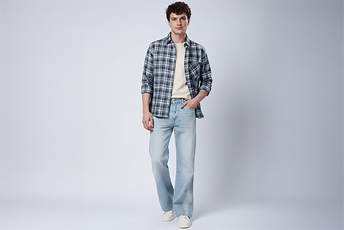 STYLOX model wearing a checked shirt and light blue jeans